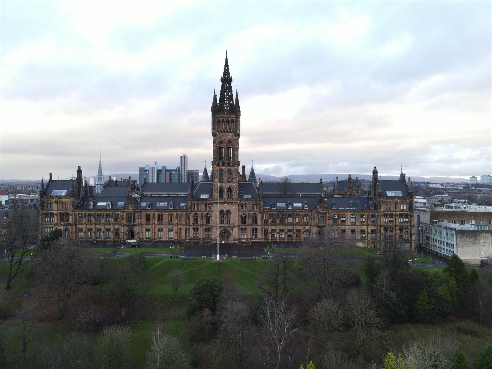 Aerial view of the University of Glasgow's Gothic Revival main building and tower above Kelvingrove Park