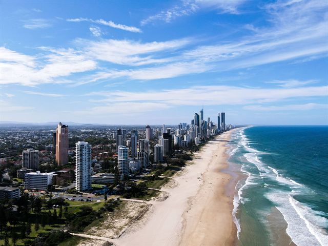 Aerial view of Gold Coast skyscrapers along a long surf beach with turquoise waves