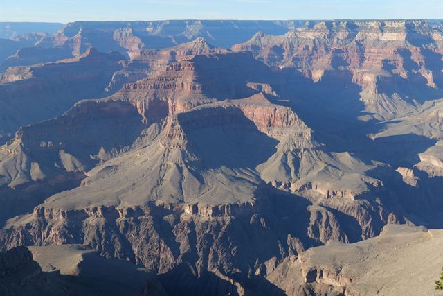 Vast Grand Canyon panorama of shadowed buttes, temples and side canyons in late-day light