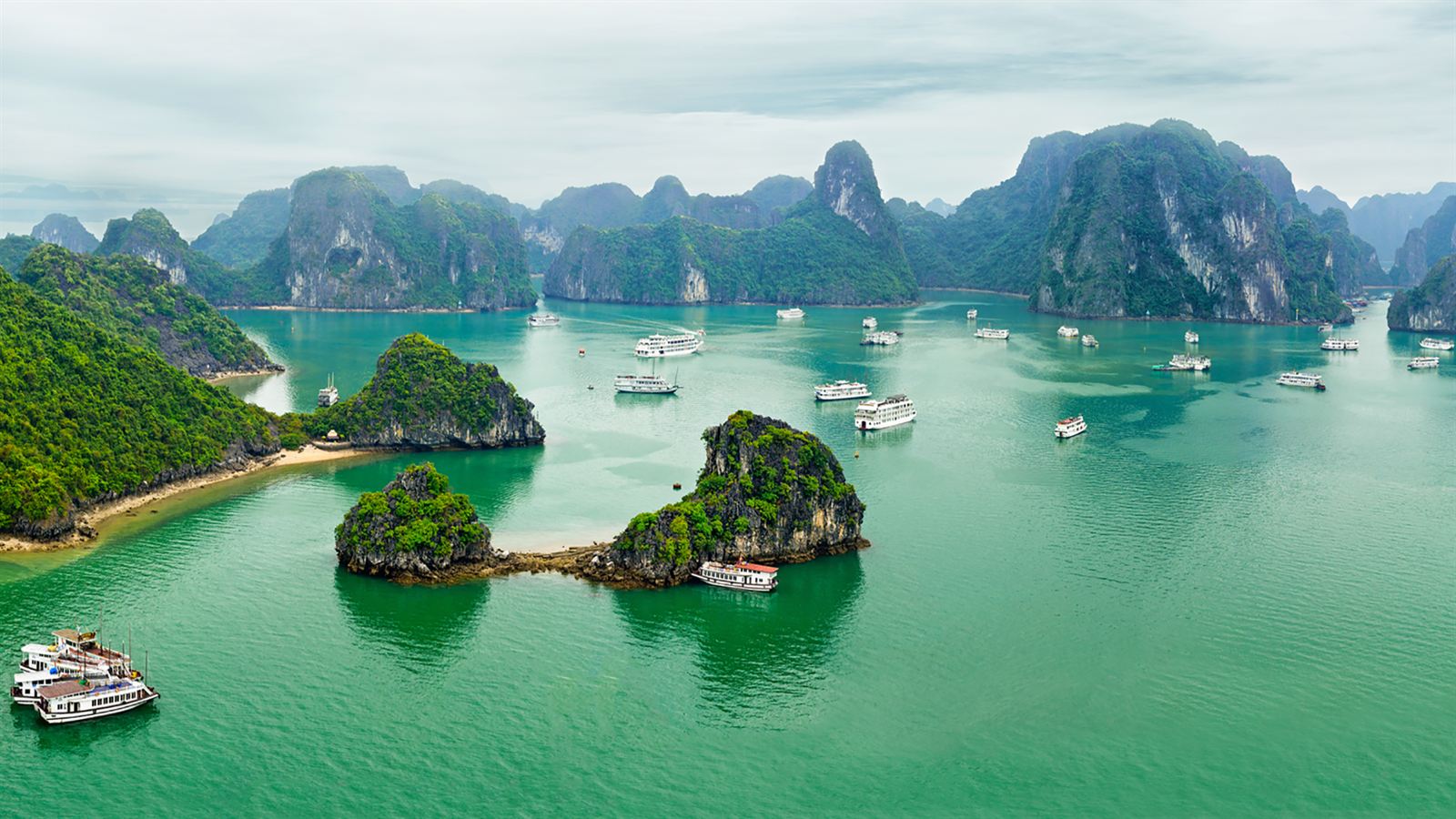 Tour boats among limestone karst islands in Halong Bay