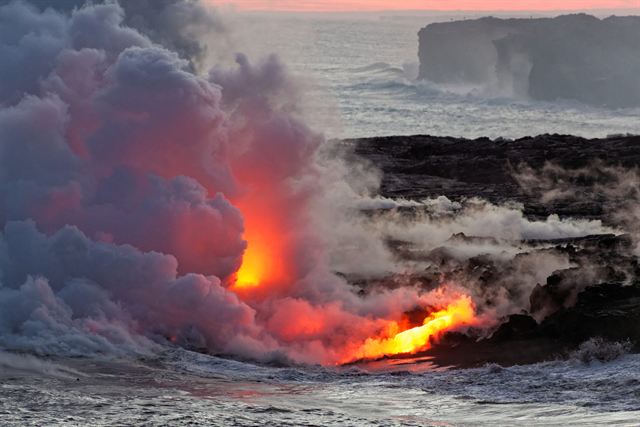 Lava pouring into the ocean in clouds of steam on the Kilauea coast, Big Island