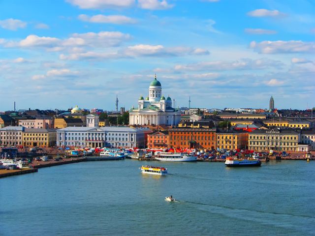 Helsinki harbour skyline seen from the water with the green-domed white Helsinki Cathedral