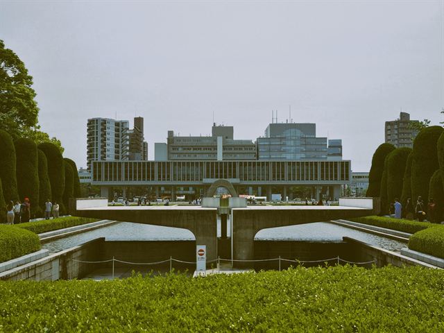 Hiroshima Peace Memorial Museum's long modernist building beyond the park's lawns and hedges