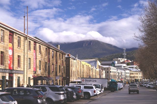 Sandstone warehouses of Salamanca Place in Hobart with kunanyi/Mount Wellington rising behind