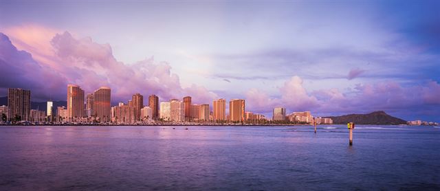Waikiki and Honolulu skyline across the water at purple dusk