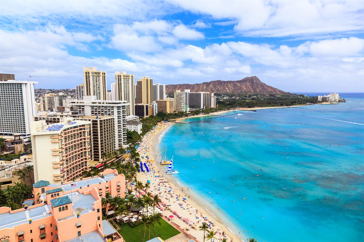 Waikiki Beach and Diamond Head from above, with the pink Royal Hawaiian at the bottom of the frame