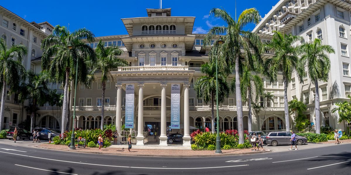 The white colonial facade and columned entrance of the Moana Surfrider on Kalakaua Avenue