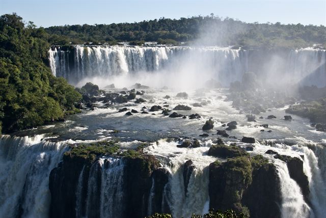 Torrents of Iguazu Falls pouring over basalt ledges in the rainforest