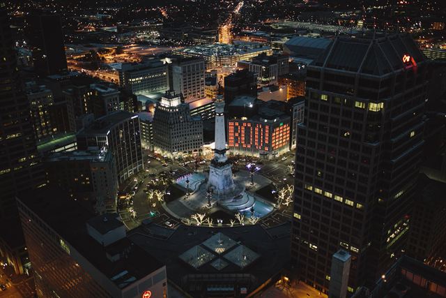 Aerial night view of Monument Circle and the Soldiers' and Sailors' Monument surrounded by downtown Indianapolis