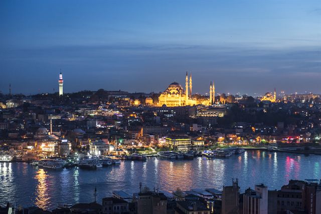 Istanbul at night across the Golden Horn with the illuminated Suleymaniye Mosque on the hill