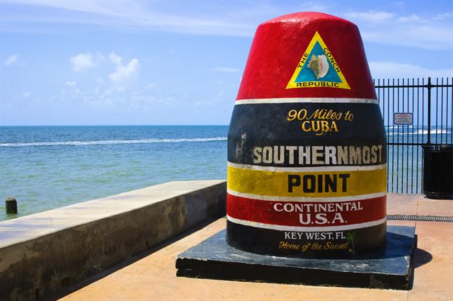 The Southernmost Point buoy in Key West beside the sea