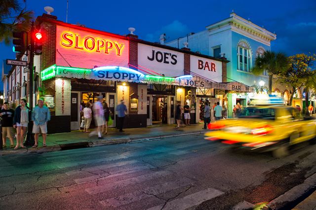 Sloppy Joe's Bar on Duval Street, Key West, lit at dusk