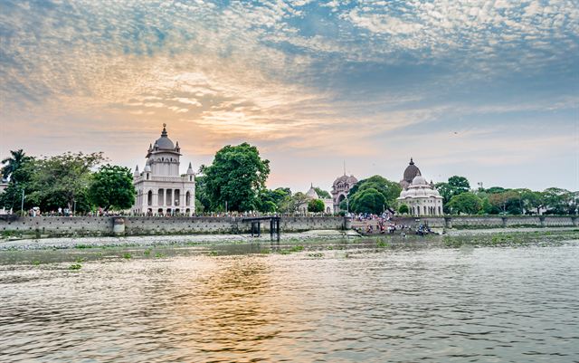 Belur Math temples on the Ganges riverbank near Kolkata under a sunset sky