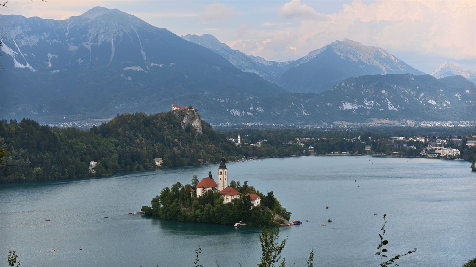 Lake Bled with Bled Island church and Bled Castle on its cliff, Julian Alps rising behind