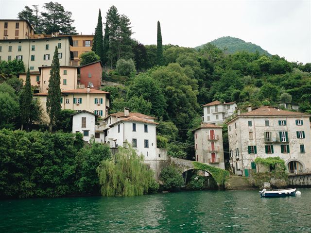 Pastel lakeside villas among cypress trees and gardens on the shore of Lake Como