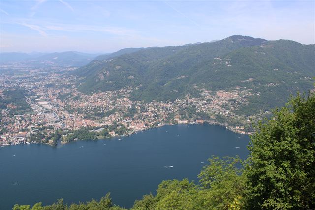 Elevated view over Lake Como's southern basin and Como town hemmed in by green mountains