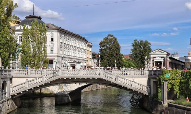 Ljubljana's Triple Bridge (Tromostovje) over the Ljubljanica River with white historic buildings