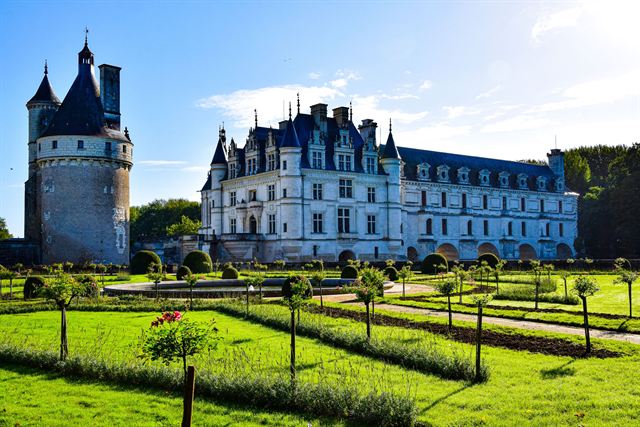 Chateau de Chenonceau in the Loire Valley with its round tower and formal green gardens