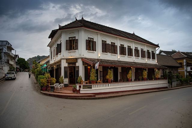 Two-storey French colonial Saynamkhan hotel on a quiet street corner in Luang Prabang, Laos