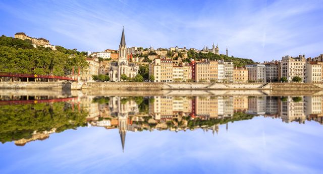 Saone riverfront in Vieux Lyon with Saint-Georges church and Fourviere hill reflected