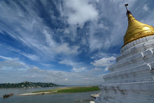 Golden and white pagoda on Sagaing Hill overlooking the wide Irrawaddy near Mandalay