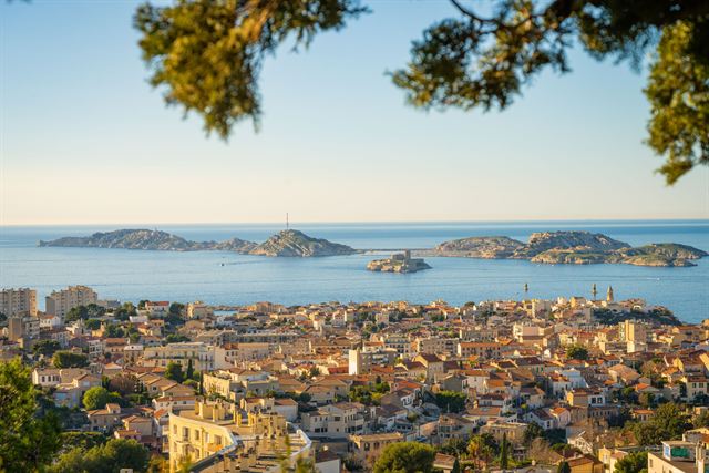 Marseille rooftops stretching to the sea with the Frioul archipelago islands offshore