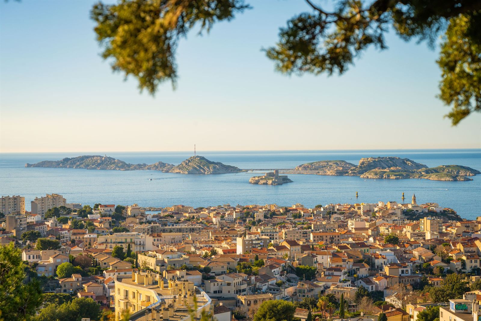 Marseille rooftops stretching to the sea with the Frioul archipelago islands offshore