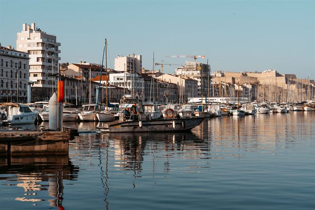 Vieux-Port of Marseille with moored boats reflected in calm water and quayside buildings