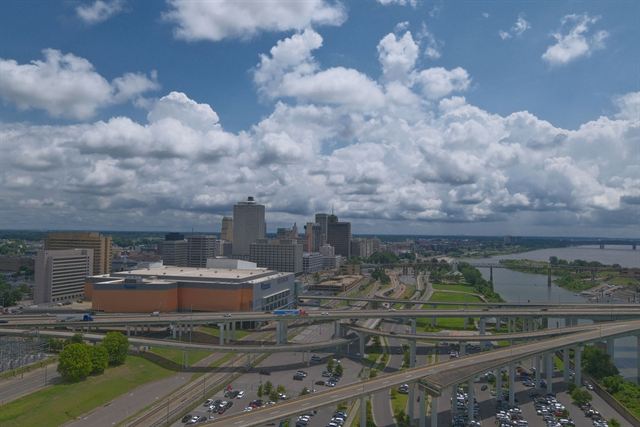 Aerial view of downtown Memphis skyline, highways and the Mississippi River under billowing clouds