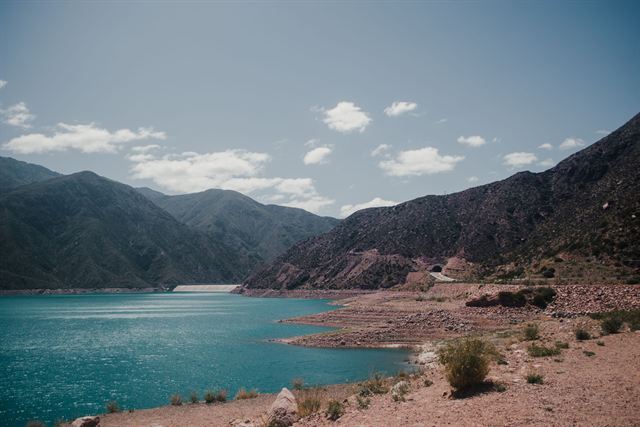 Turquoise Potrerillos reservoir surrounded by rugged Andes foothills in Mendoza, Argentina