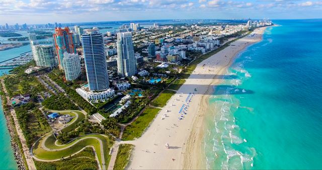 Aerial view of Miami Beach from South Pointe with high-rises, beach and turquoise water