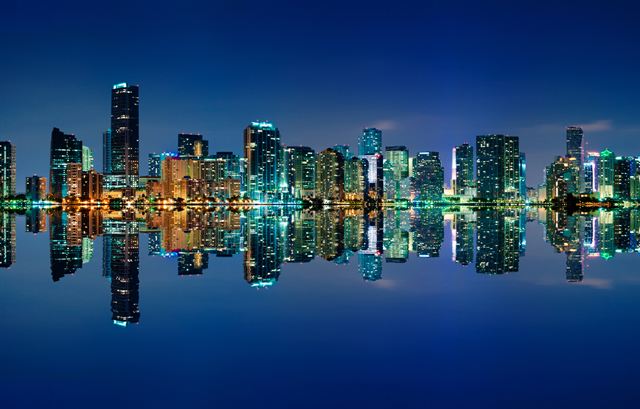 Miami skyline at night reflected in Biscayne Bay