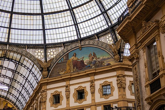 Glass dome and painted lunette mosaic inside Galleria Vittorio Emanuele II shopping arcade in Milan