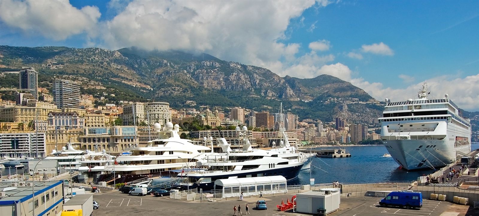 Superyachts and a cruise ship in Monaco's Port Hercule below Monte Carlo