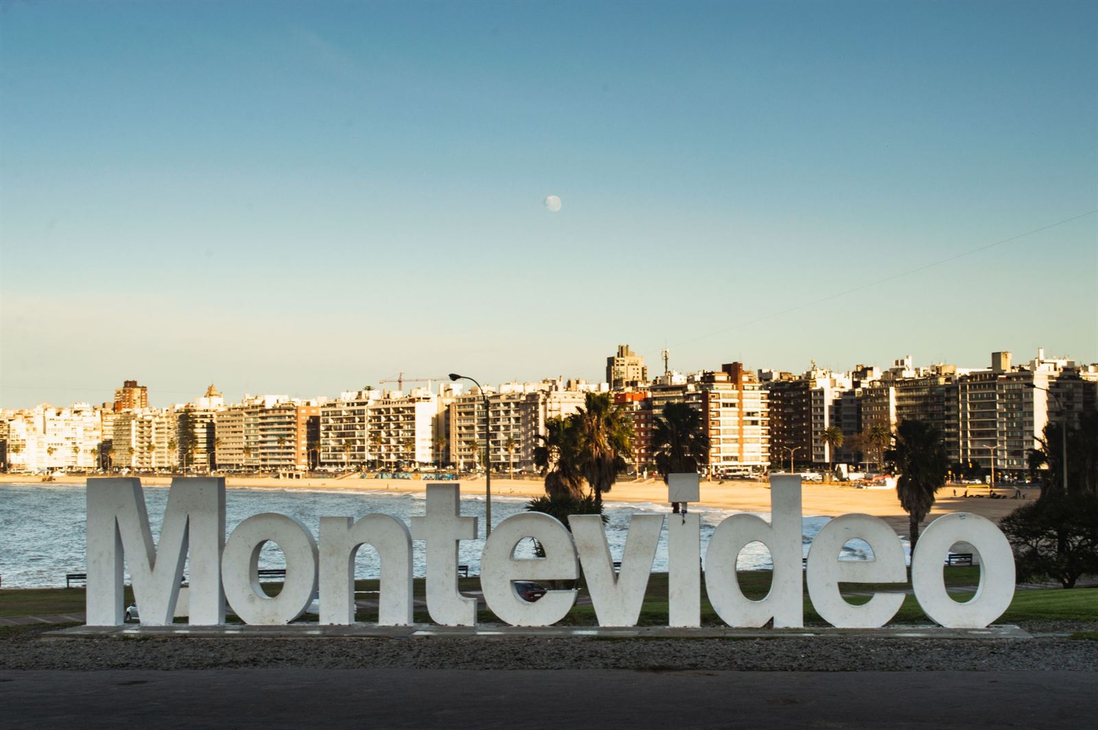 Giant Montevideo letters sign on the Pocitos waterfront with the beachfront apartment skyline behind