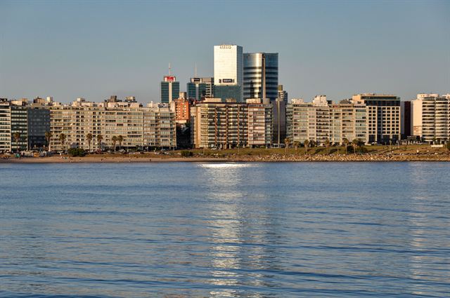 Montevideo skyline of apartment blocks and towers seen across the calm Rio de la Plata waters