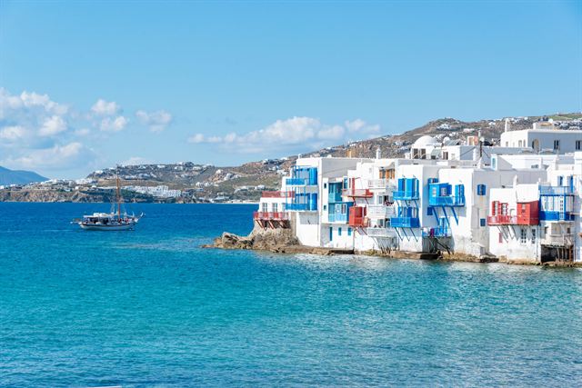 Little Venice in Mykonos Town, white and colorful waterfront houses on turquoise Aegean water