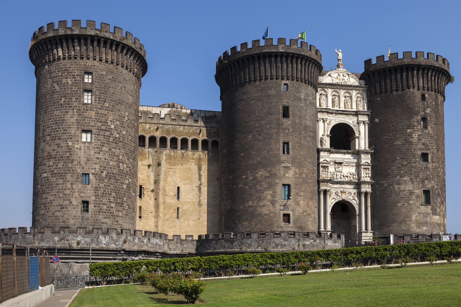 Castel Nuovo's round stone towers and marble entrance arch in central Naples