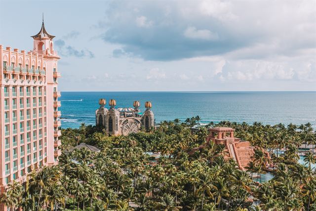 Atlantis Paradise Island's pink Royal Towers, Mayan Temple waterslide and palm grounds above the ocean, Nassau