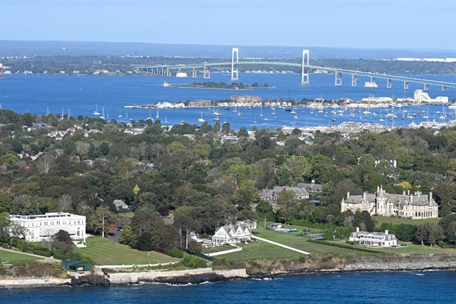 Aerial view of Newport mansions and coast with the harbor and Claiborne Pell Newport Bridge beyond