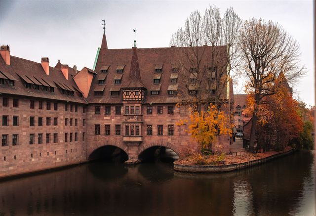 Heilig-Geist-Spital, Nuremberg's medieval hospital built on arches over the Pegnitz river, in autumn