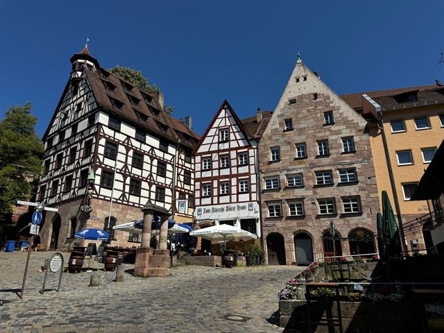 Half-timbered houses on Tiergartnertor square in Nuremberg old town under deep blue sky
