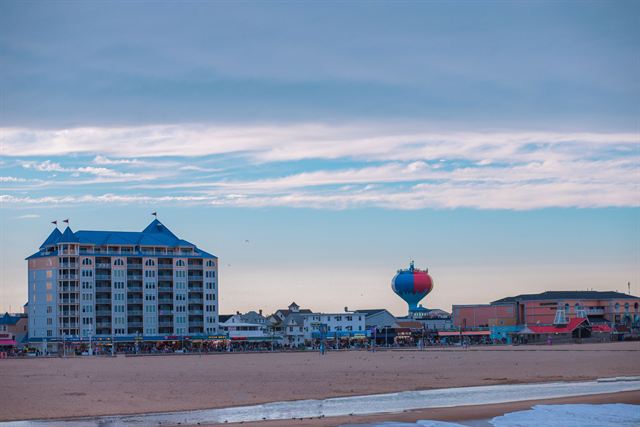 Ocean City, Maryland beach and boardwalk with a hotel and the colorful beach-ball water tower