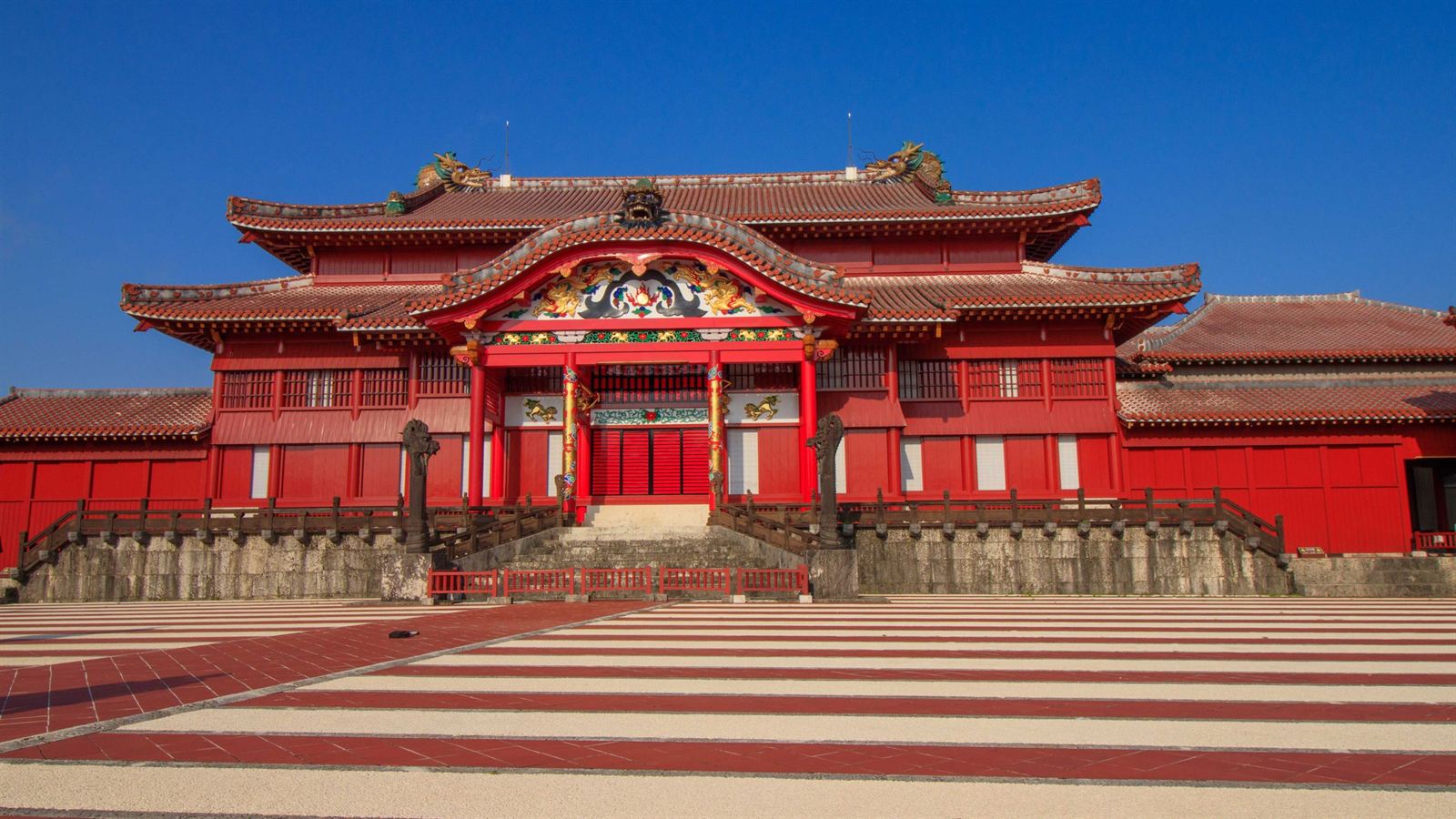 Red-lacquered Seiden main hall of Shuri Castle in Naha, Okinawa, under clear blue sky