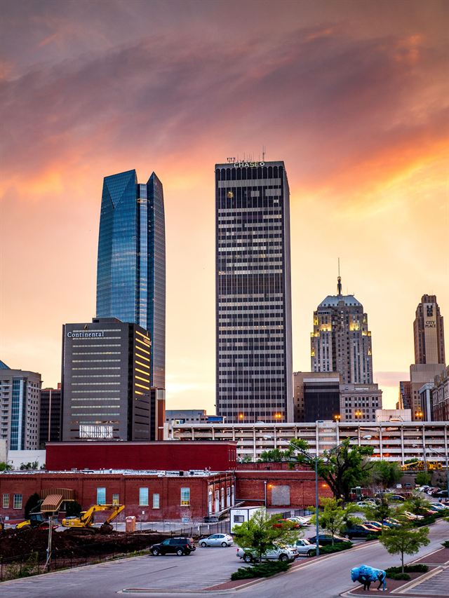 Oklahoma City skyline with Devon Tower and downtown towers under a dramatic sunset sky