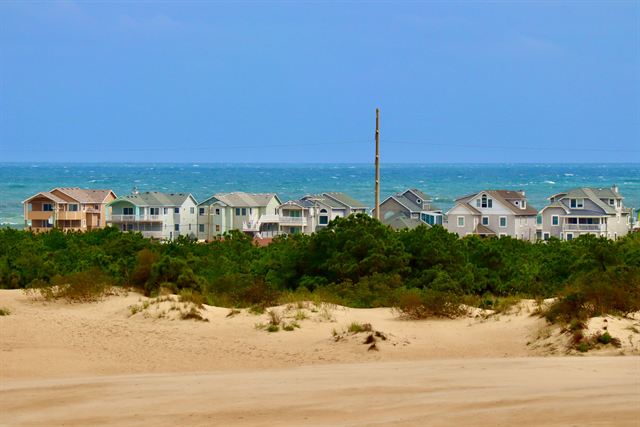 Colorful beach houses on the dunes above the Atlantic at Nags Head on the Outer Banks