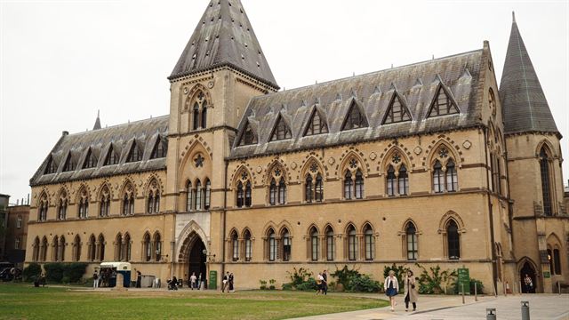 Gothic Revival Oxford University Museum of Natural History facade with lawn in front