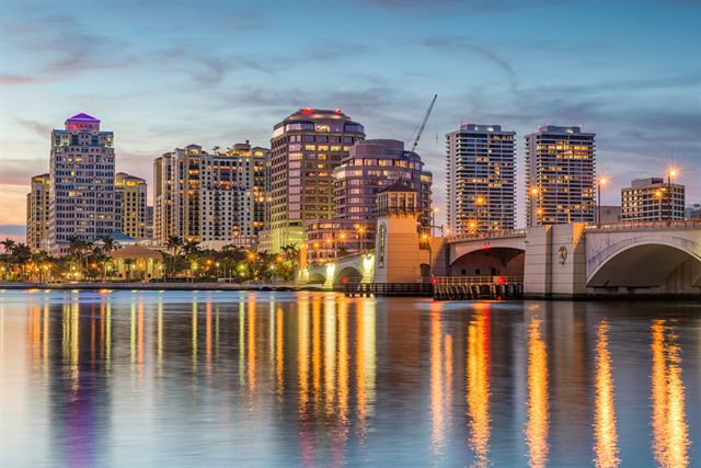 West Palm Beach waterfront towers and bridge reflected in the Intracoastal at dusk