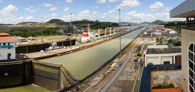 Miraflores Locks on the Panama Canal with a ship in the chamber under blue sky