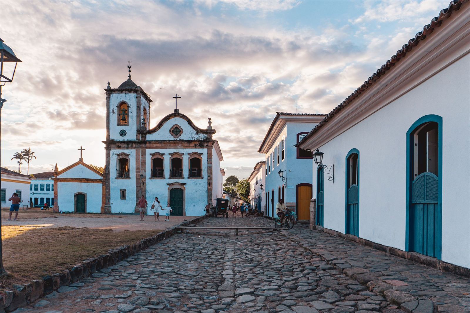Historic white church and colonial houses facing a cobblestone square in Paraty, Brazil